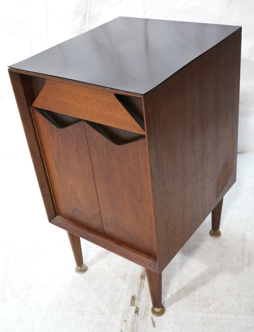 GROSFELD HOUSE American Modern Walnut Side Table.: GROSFELD HOUSE American Modern Walnut Side Table. Cabinet. One Drawer. Bifold Door. Black Laminate Top. Triangle cut out pull details. Label-- Dimensions: H: 29.75 inches: W: 16.75 inches: D: 19 inche