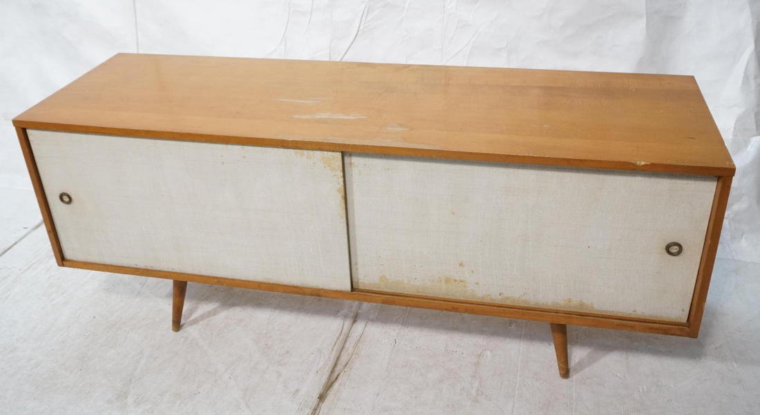 Low PAUL McCOBB Sliding Door Cabinet. Maple Cabin: Low PAUL McCOBB Sliding Door Cabinet. Maple Cabinet with White fabric sliding doors. Slanted peg legs. -- Dimensions: H: 25.5 inches: W: 60 inches: D: 18.25 inches ---