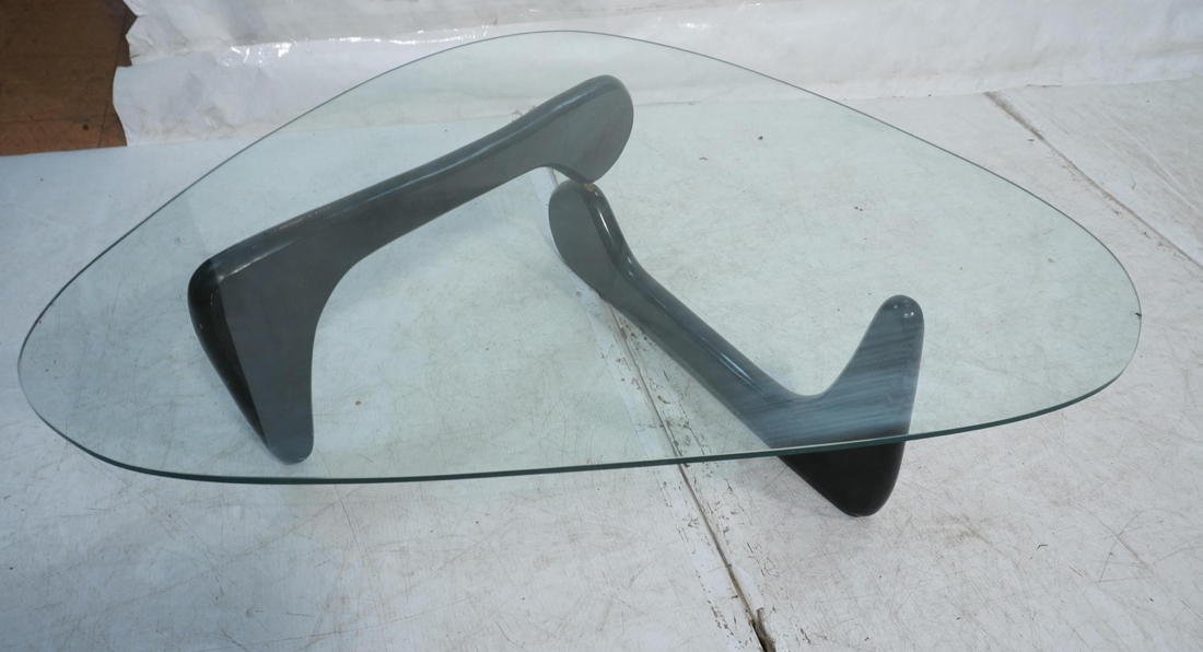 Noguchi style Coffee Cocktail Table. Ebonized bas: Noguchi style Coffee Cocktail Table. Ebonized base. Triangular glass top. Metal pin connector for base. -- Dimensions: H: 14.25 inches: W: 48 inches: D: 35 inches ---