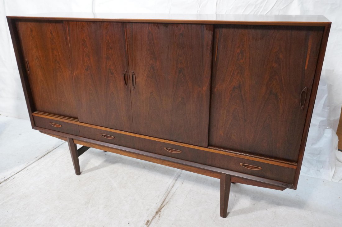 Tall Rosewood Danish Modern Credenza. Four slidin: Tall Rosewood Danish Modern Credenza. Four sliding doors over four drawers. Interior shelves & drawers. Mirror back bar cabinet. -- Dimensions: H: 47 inches: W: 74 inches: D: 17.5 inches ---