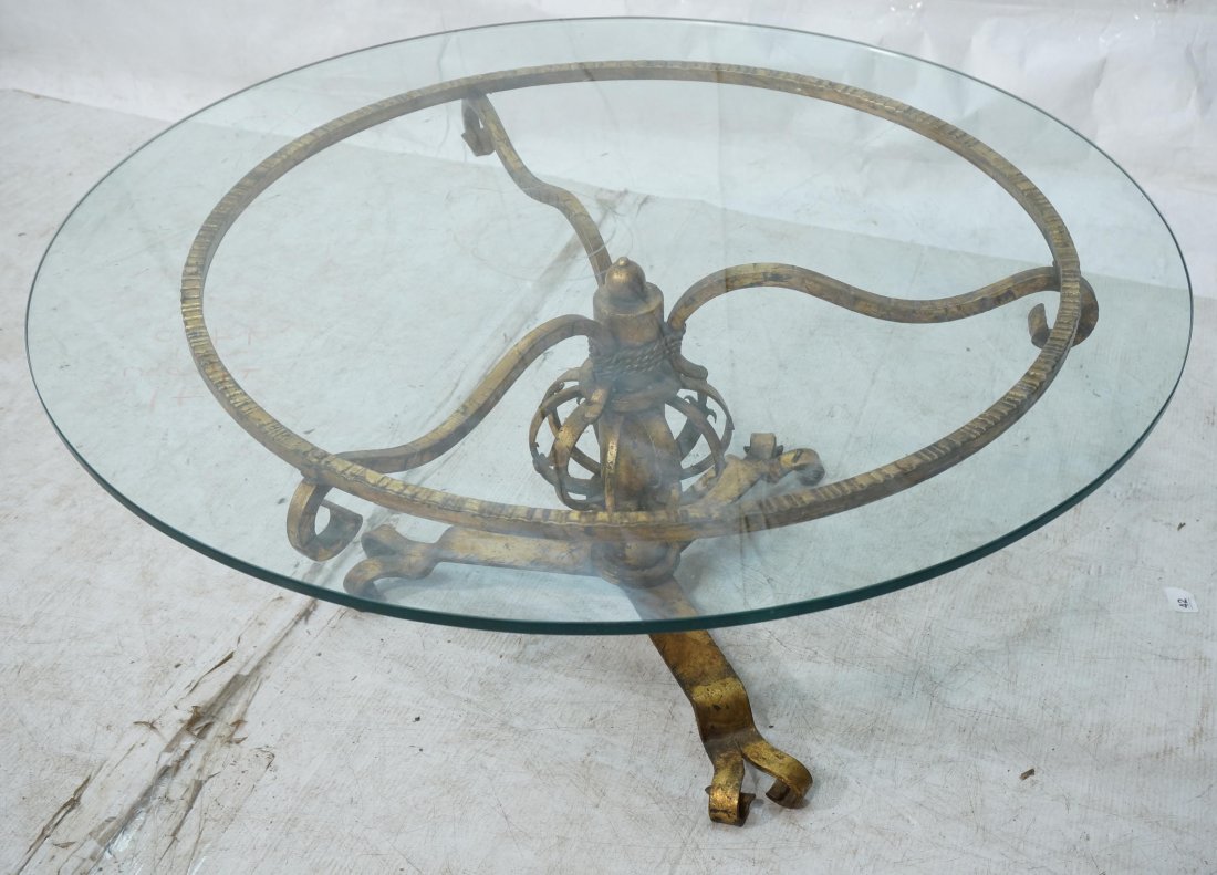Glass Top Iron Base Coffee Table. Decorator Gold: Glass Top Iron Base Coffee Table. Decorator Gold Gilt Wrought Iron.-- Dimensions: H: 17 inches: W: 36 inches: D: 36 inches ---