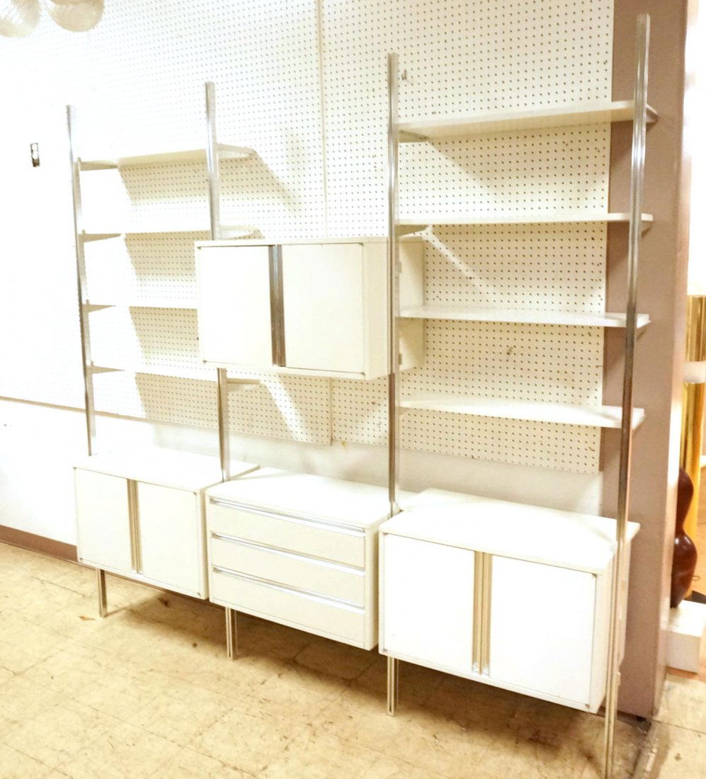 OMNI White Laminate Wall Shelf Unit. Aluminum Upr: OMNI White Laminate Wall Shelf Unit. Aluminum Uprights. 3 Laminate Cabinets with aluminum accents. One Section with three drawers. Nine shelves.-- Dimensions: H: 89.5 inches: W: 93 inches: D: 15 inche