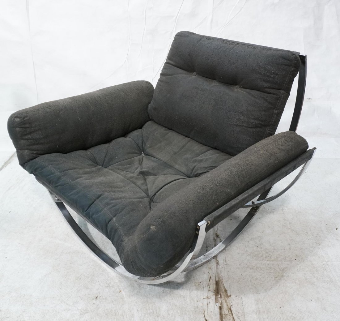 Milo Baughman style Chromed Steel Wide Lounge Cha: Milo Baughman style Chromed Steel Wide Lounge Chair. Four opposing bowed legs. Black Pleather Cushion Seat. Not marked-- Dimensions: H: 29.5 inches: W: 42 inches: D: 40 inches ---