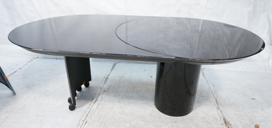 ROUGIER Black Lacquer Oval Dining Table. Two leav: ROUGIER Black Lacquer Oval Dining Table. Two leaves: unique curved leaf system. Base has wheels. Marked.-- Dimensions: H: 29 inches: W: 73 inches: D: 44 inches ---