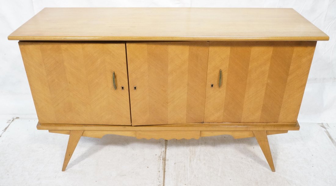 Modernist Blond Wood Three Door Credenza. Tapered: Modernist Blond Wood Three Door Credenza. Tapered peg legs. Decorative sides and skirt.-- Dimensions: H: 37 inches: W: 60 inches: D: 20 inches ---