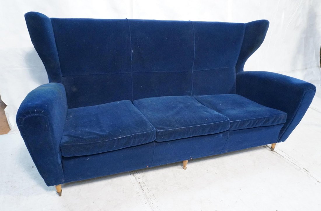 MELCHIORRE BEGA Retro Blue Three Seater Sofa couc: MELCHIORRE BEGA Retro Blue Three Seater Sofa couch. Wood peg legs. Gio Ponti style. Rich blue fabric upholstery. Tall wide wing back. Not marked. -- Dimensions: H: 40 inches: W: 77 inches: D: 34 inche