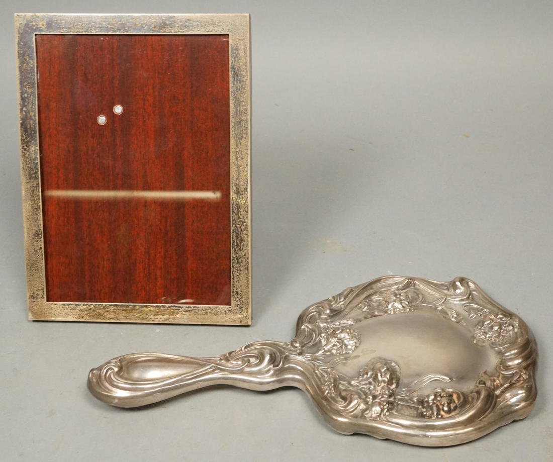2pc Sterling Lot. 1) CARTIER Signed Sterling Pict: 2pc Sterling Lot. 1) CARTIER Signed Sterling Picture Frame. Wood Easel back. Marked; 925. 2) SILVER PLATE Hand Mirror. Art Nouveau Floral Design. Marked.-- Dimensions: H: 7.5 inches: W: 5.5 inches---