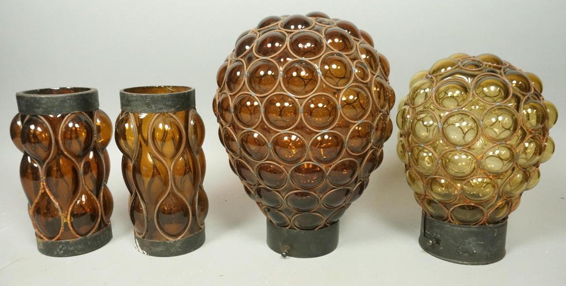 4pc. Amber Glass Modernist Shades. Amber glass bl: 4pc. Amber Glass Modernist Shades. Amber glass blown into metal wire frames. Different colored glass. -- Dimensions: H: 12 inches: W: 8.5 inches --- US Shipping charge: $50