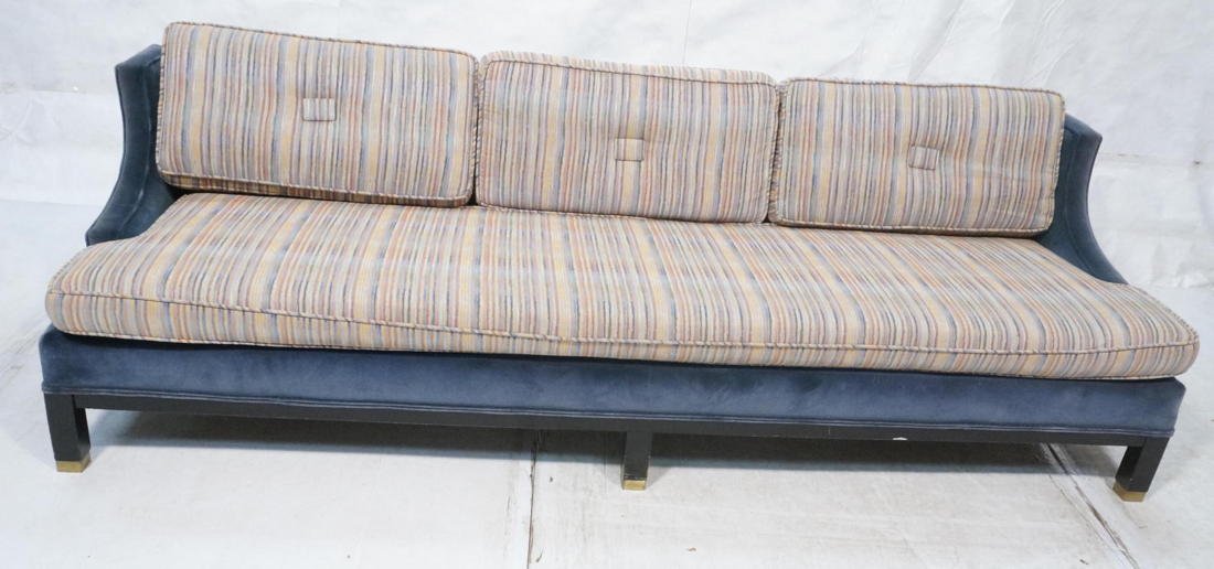 Dunbar style Long Sofa Couch. Upholstered body in: Dunbar style Long Sofa Couch. Upholstered body in contrasting blue velvet frame with striped fabric cushions. Square dark wood legs with brass caps. -- Dimensions: H: 26.5 inches: W: 91 inches: D: 33 