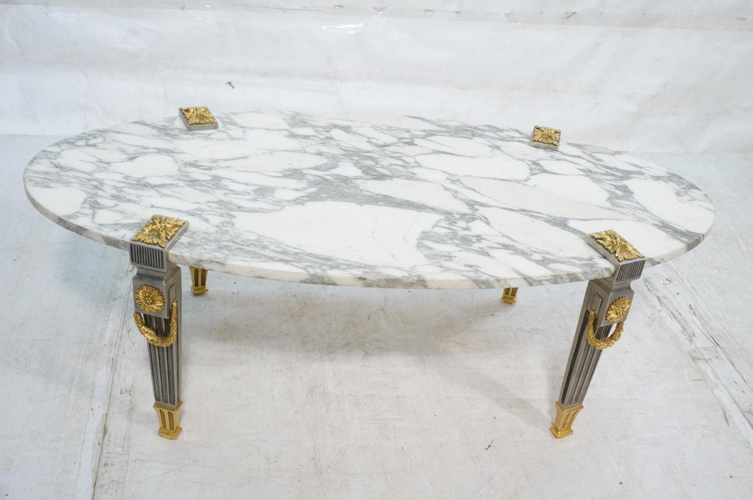 P.E. Guerin Coffee Cocktail Table. Gilt and silv: P.E. Guerin Coffee Cocktail Table. Gilt and silvered Bronze Legs with Oval Marble Top.-- Dimensions: H: 17 inches: W: 48 inches: D: 24 inches ---
