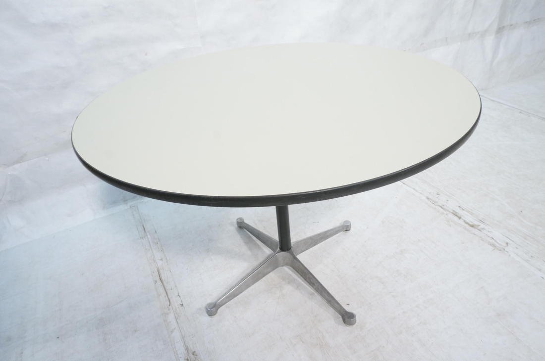 HERMAN MILLER Round Laminate Top Dining Table. Bl: HERMAN MILLER Round Laminate Top Dining Table. Black pedestal with four aluminum feet. Dark gray rubber trim-- Dimensions: H: 28.75 inches: W: 41 inches: D: 41 inches ---