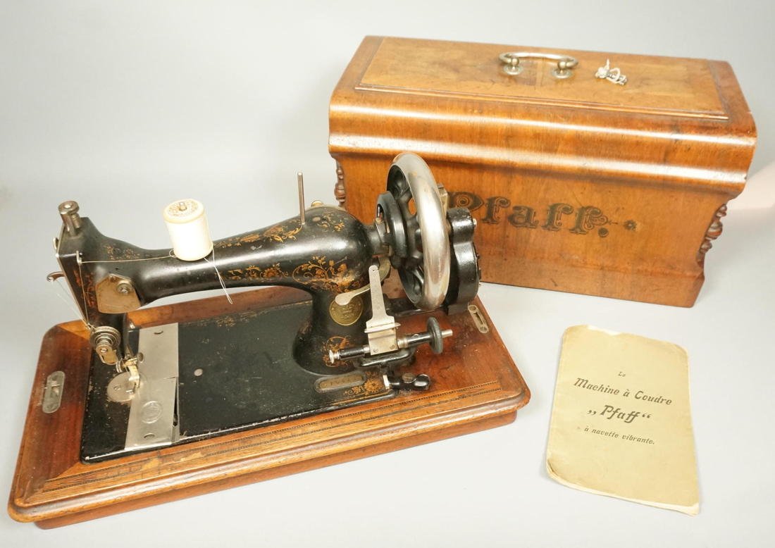 Antique Pfaff Lightweight Sewing Machine in Label: Antique Pfaff Lightweight Sewing Machine in Labeled Wood Case. Nice wood case with column details. Hand crank-- Dimensions: H: 12 inches: W: 18 inches: D: 9 inches ---