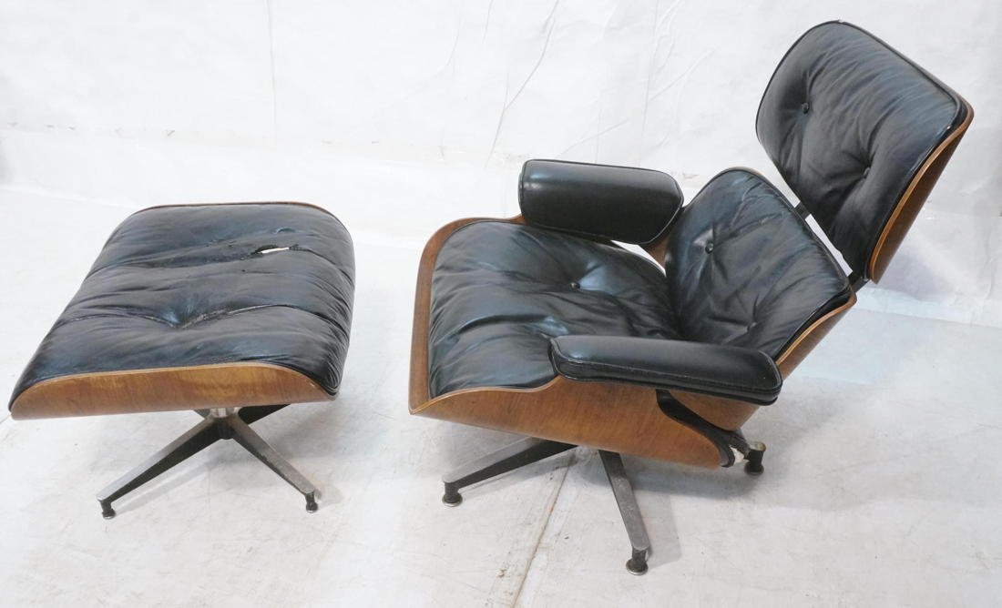 CHARLES EAMES Walnut Lounge Chair Ottoman. Black: CHARLES EAMES Walnut Lounge Chair Ottoman. Black Leather. Early model with down cushions #670. Herman Miller. Marked. -- Dimensions: H: 33 inches: W: 33 inches: D: 31 inches ---