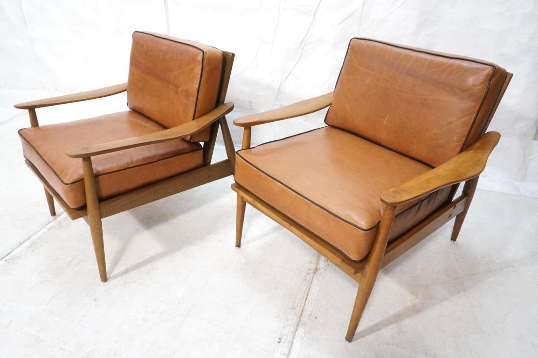 Pr American Modern Lounge Chairs. Wide flat paddl: Pr American Modern Lounge Chairs. Wide flat paddle arms. Swollen tapered legs. Brown leather seat & back cushions with black piping trim.-- Dimensions: H: 30 inches: W: 29.25 inches: D: 26 inches ---