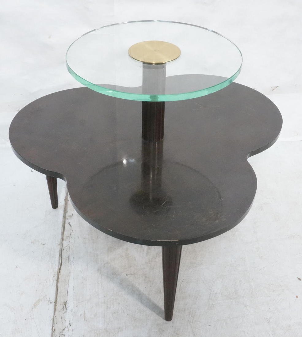 GILBERT ROHDE Two Tier Decorator Side Occasional: GILBERT ROHDE Two Tier Decorator Side Occasional Table. Lower Clover Leaf Tier with Round Thick Glass Upper Tier. Fluted column detail with large brass cap. Elegant reeded tapered legs. -- Dimensions: