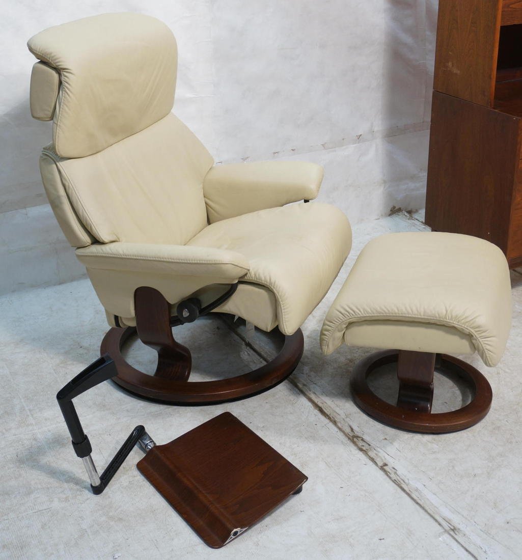 Ekornes Stressless lounge chair and ottoman with: Ekornes Stressless lounge chair and ottoman with attachable table. Tan Leather.-- Dimensions: H: 44 inches: W: 37 inches: D: 32 inches ---
