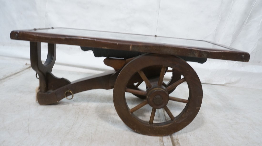 Cannon Form Coffee Cocktail Table. Carved wood fr: Cannon Form Coffee Cocktail Table. Carved wood frame with inset glass top. 6 pounder. -- Dimensions: H: 17.5 inches: W: 51.25 inches: D: 21 inches ---