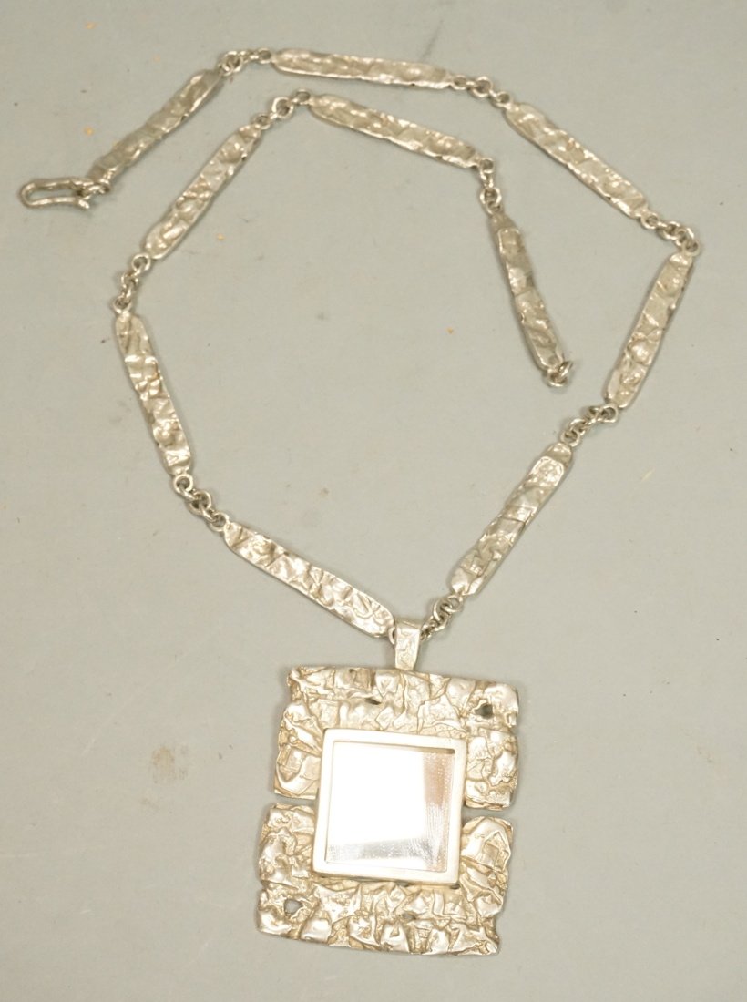 RACHEL GERA Israel Sterling Mirror Pendant. Leadi: RACHEL GERA Israel Sterling Mirror Pendant. Leading Israeli Modernist jeweler designed piece. Square Form pendant with inset square mirror. Hand wrought large link neck chain. Marked. Pendant measures
