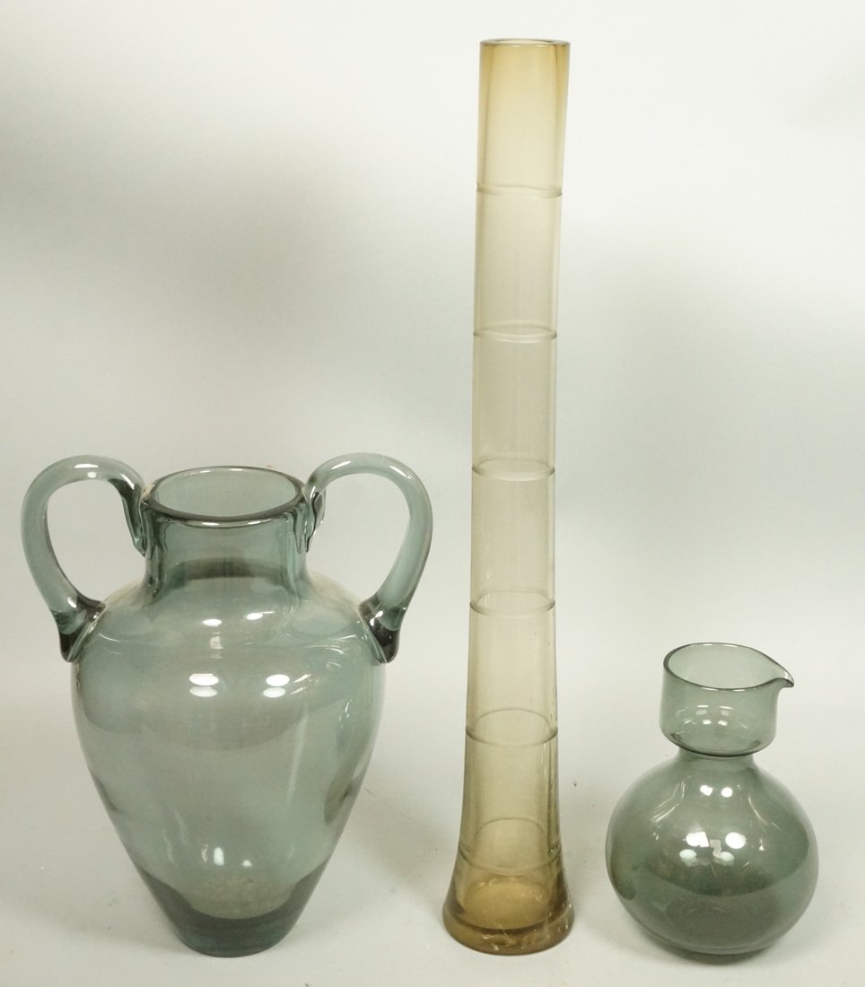 3pc Art Glass Lot. 1. SALVIATI Italian Murano Tal: 3pc Art Glass Lot. 1. SALVIATI Italian Murano Tall Beaker Vase. Bamboo form. Signed. 2002.2. HOLMEGAARD Sonia 68 Pitcher. 3. Tall two handled Smoky blue glass vase. -- Dimensions: H: 23.5 inches: W: 3