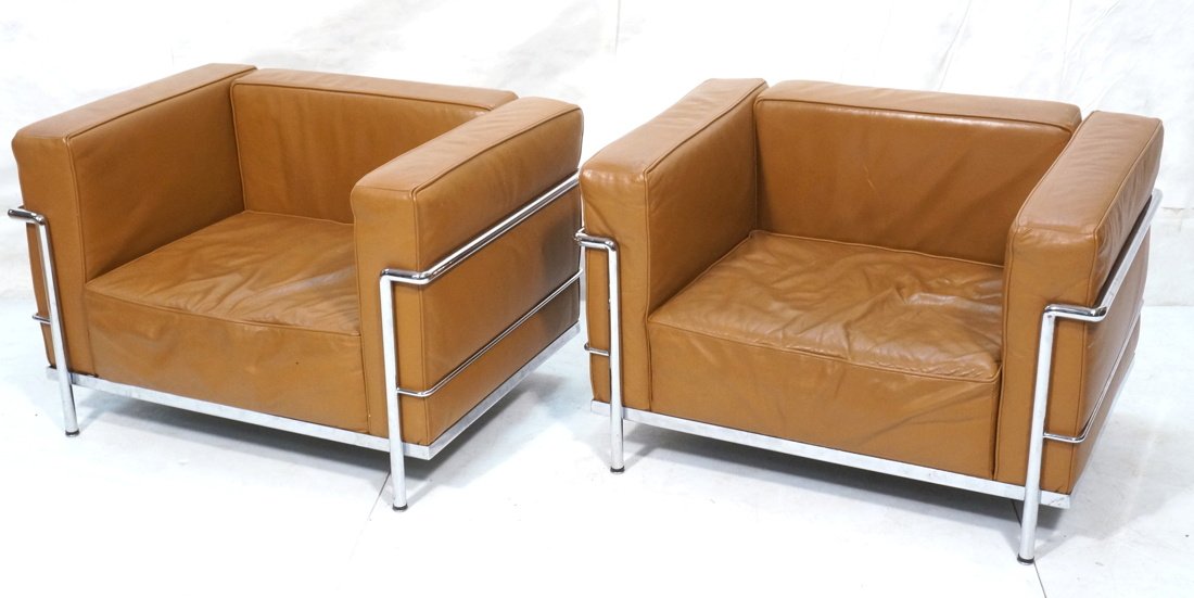 Pr Italian Le Corbusier style Arm Lounge Chairs.: Pr Italian Le Corbusier style Arm Lounge Chairs. Chrome tubular frames. Light brown leather cushions. Marked Italy. -- Dimensions: H: 26 inches: W: 39 inches: D: 29 inches ---