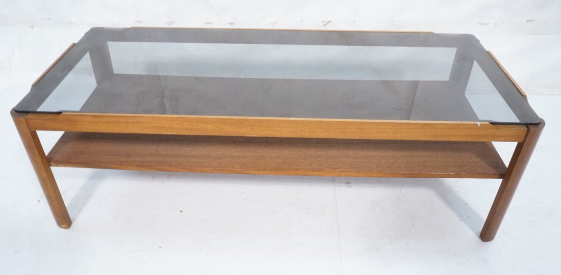 American Modern Coffee Cocktail Table. Inset smok: American Modern Coffee Cocktail Table. Inset smoked glass top. Lower wood shelf. -- Dimensions: H: 14 inches: W: 44 inches: D: 18.75 inches ---