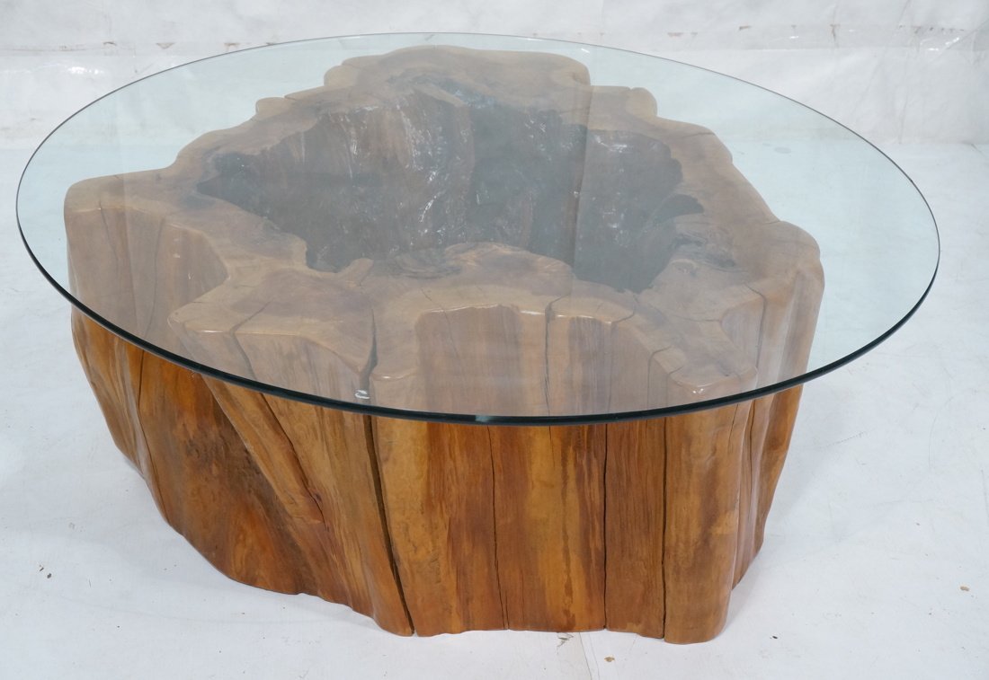 Large Wood Tree Trunk Base Glass Top Coffee Table: Large Wood Tree Trunk Base Glass Top Coffee Table. Round glass top on thick freeform hollow trunk base. -- Dimensions: H: 17.5 inches: W: 38 inches: D: 38 inches ---
