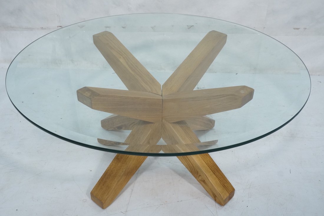 Glass Top Wood Starburst Base Modernist Coffee Ta: Glass Top Wood Starburst Base Modernist Coffee Table. Round glass top cocktail table with corseted wood arm base-- Dimensions: H: 17 inches: W: 36 inches: D: 36 inches ---
