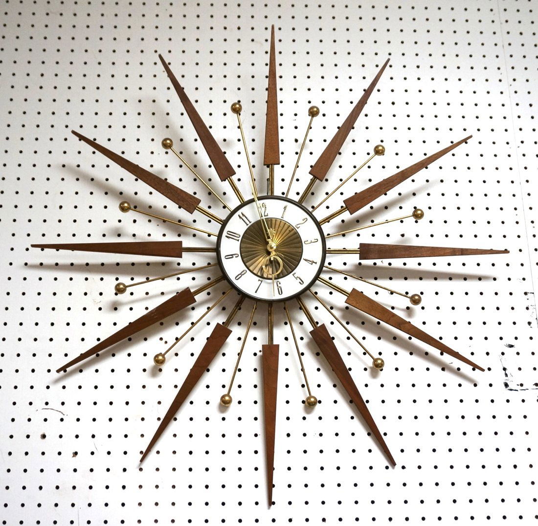 ELGIN Walnut Starburst Wall Clock. Modernist Wood: ELGIN Walnut Starburst Wall Clock. Modernist Wood Points with brass ball accents. Battery Op. -- Dimensions: H: 31 inches: W: 31 inches ---