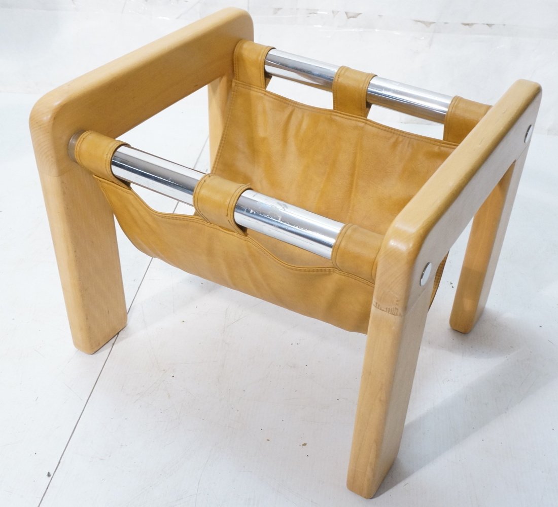 Wood and chrome magazine rack. Tan leather catch.: Wood and chrome magazine rack. Tan leather catch. Chrome tubes with chrome accents on the side.-- Dimensions: H: 18 inches: W: 21 inches: D: 19 inches ---