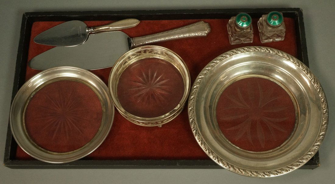 7pc Sterling Lot. 2 sterling handled servers. 2 E: 7pc Sterling Lot. 2 sterling handled servers. 2 Enamel Sterling top crystal salt & pepper shakers. Crystal low bowl with sterling overlay; Glass is chipped. 2 sterling rimmed crystal wine coasters dis