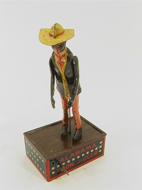 Strauss TOMBO Tin Alabama Coon Jigger dancing toy: Strauss TOMBO Tin Alabama Coon Jigger dancing toy Dimensions: H: 10 inches Condition: Dings to paint. Metal in good condition. Metal rod that should hold up figure is replaced with stiff wire. Operati