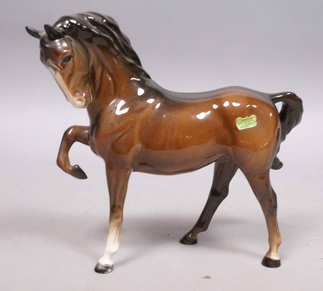 BESWICK England Dark Brown Horse Figure. Leg rais: BESWICK England Dark Brown Horse Figure. Leg raised. Foil sticker. Marked-- Dimensions: H: 8 inches: W: 8.25 inches: D: 3 inches ---
