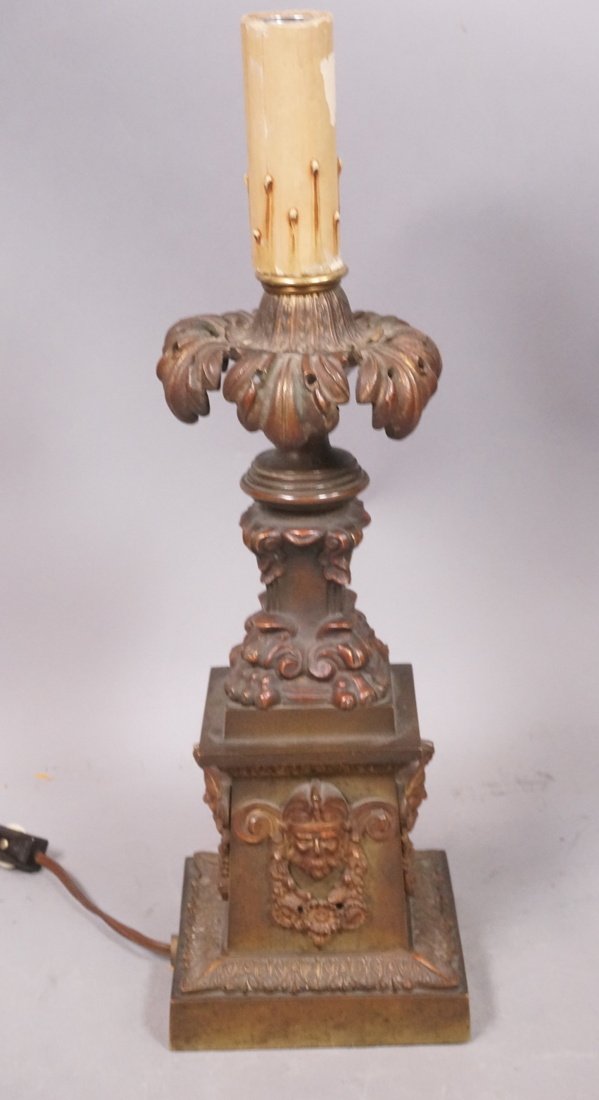 Antique Bronze Table Lamp. Relief heads with flor: Antique Bronze Table Lamp. Relief heads with floral swag elements. -- Dimensions: H: 16 inches: W: 5 inches: D: 5 inches ---