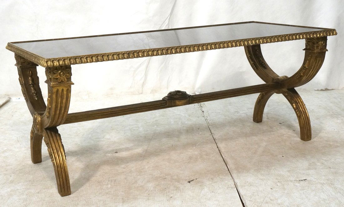 Italianate style Coffee Table. Carved Gilt Wood B: Italianate style Coffee Table. Carved Gilt Wood Base with opaque black glass top. Bowed "X" Form sides-- Dimensions: H: 18 inches: W: 44.25 inches: D: 21 inches ---