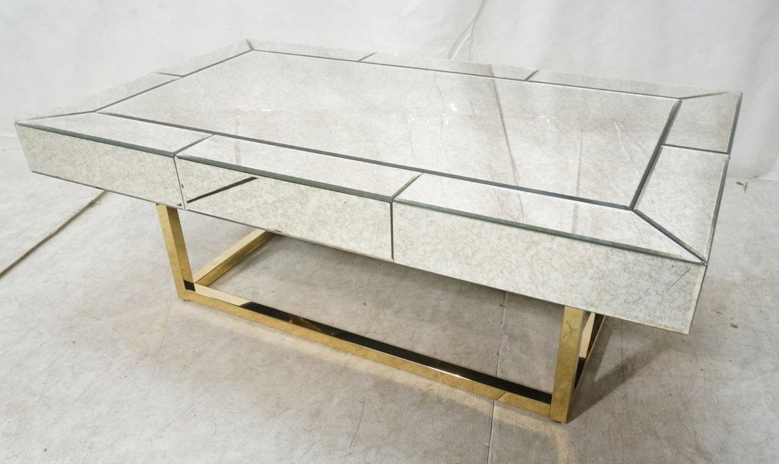 Modernist Antiqued Mirror Cocktail Table: Modernist Antiqued Mirror Cocktail Table. Brass frame base coffee table. -- Dimensions: H: 16.5 inches: W: 47.25 inches: D: 27.75 inches ---
