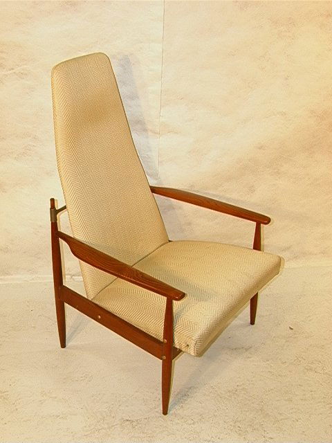 JENS QUISTGAARD Style Paddle Arm Chair. Wood Frame: JENS QUISTGAARD Style Paddle Arm Chair. Wood Framed Chair with Metal Back Support. Large Wide Cushioned Seat and Tapered Back. Attribution Unsigned. Dimensions: H: 45 inches: W: 27.5 inches: D: 27.5 i
