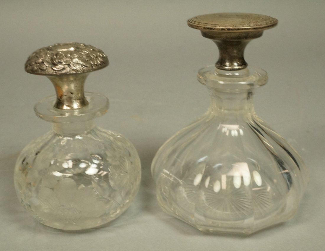 2 Sterling Lidded Crystal Perfume Bottles. One bo: 2 Sterling Lidded Crystal Perfume Bottles. One bottle with engraved flowers and STEIFF Sterling Stopper. -- Dimensions: H: 5 inches: W: 3.75 inches --- US Shipping charge: $20
