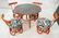 Red Painted Rattan Table & Four Low Chairs. Black