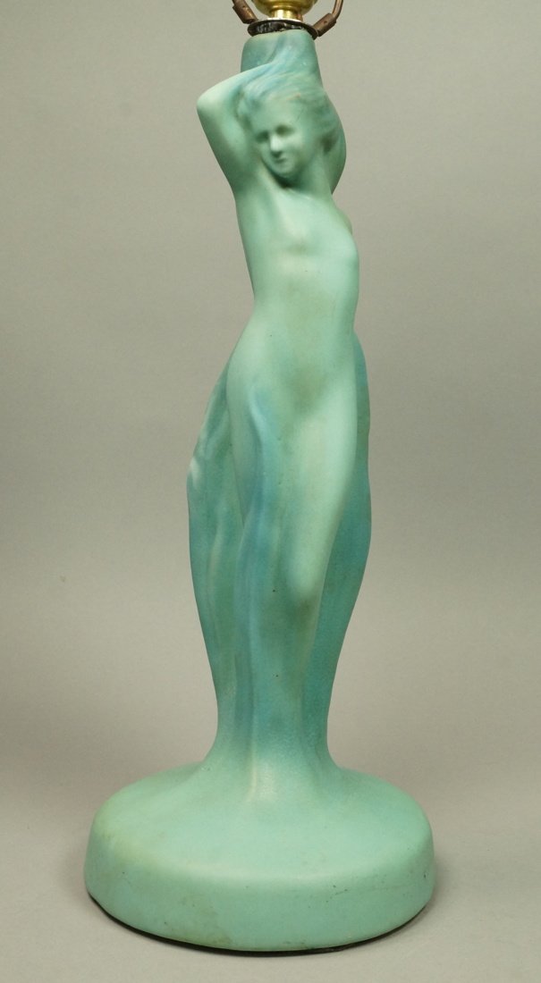 ARTUS VAN BRIGGLE Lamp American Art Pottery Lamp.: ARTUS VAN BRIGGLE Lamp American Art Pottery Lamp. Nude female figural lamp base. Blue green glaze. Daughter of the Flame. Marked (Faintly) near the cord hole..-- Dimensions: H: 33 inches: W: 7 inches 
