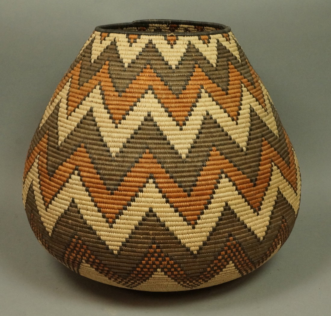 Large Indian Woven Basket. Warm browns & tan wove: Large Indian Woven Basket. Warm browns & tan woven chevron design. Not marked.-- Dimensions: H: 17 inches: W: 18 inches: D: 18 inches ---