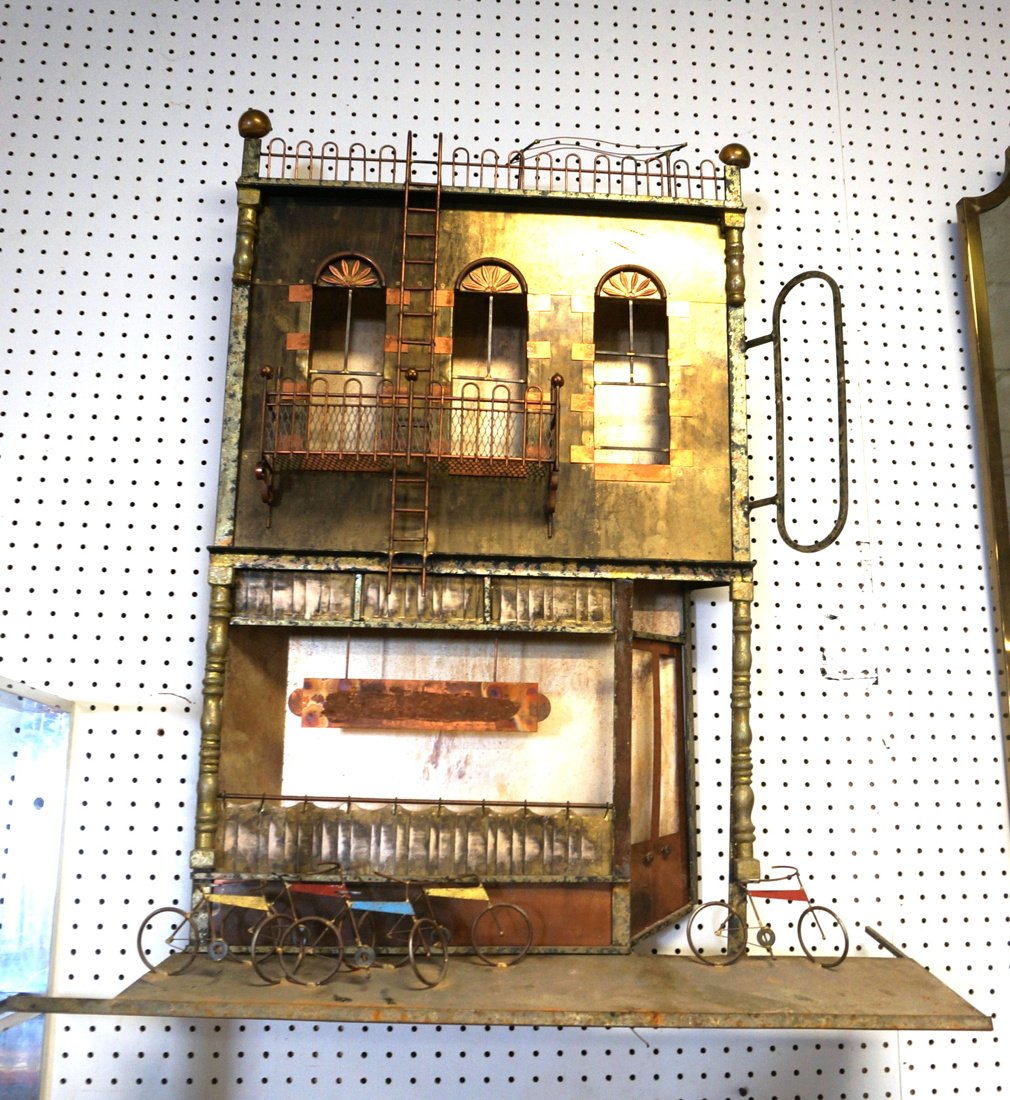 C JERE Mixed metal Wall Sculpture. Storefront bui: C JERE Mixed metal Wall Sculpture. Storefront building with bikes. Signed.-- Dimensions: H: 38 inches: W: 34 inches: D: 8.5 inches ---