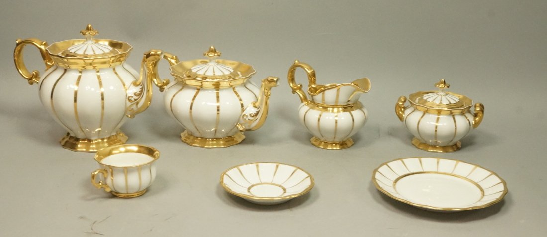 29pc Bone China Tea, Coffee & Dessert Set. White: 29pc Bone China Tea, Coffee & Dessert Set. White china with gold rims and stripes. Coffee pot. Teapot. Sugar, Creamer. Cups and Saucers. Marked with F. -- Dimensions: H: 8.5 inches: W: 11 inches: D: 6