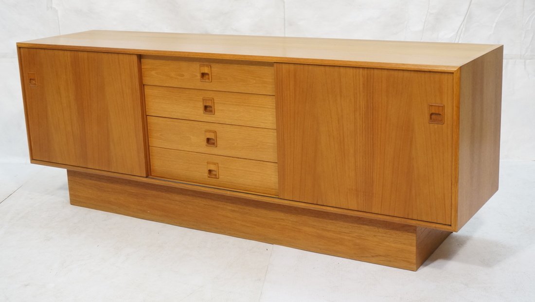 Danish Modern Teak credenza sideboard. 2 sliding: Danish Modern Teak credenza sideboard. 2 sliding doors and 4 drawers with recessed wood pulls. Raised on block base.-- Dimensions: H: 27 inches: W: 72 inches: D: 18 inches ---