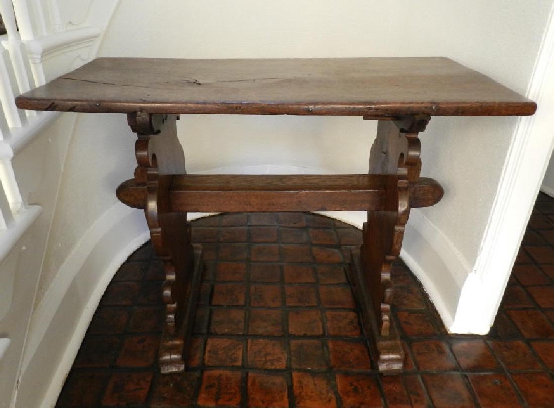 Antique Louis XIII Style Trestle Table: An antique Louis XIII style chestnut trestle table, h. 30" x w. 39 3/4" x d. 19 1/4". Une table antique tenon et mortaise, de style Louis XIII, en noyer, h. 30 "x p. 39 3/4" x d. 19 1/4 ".