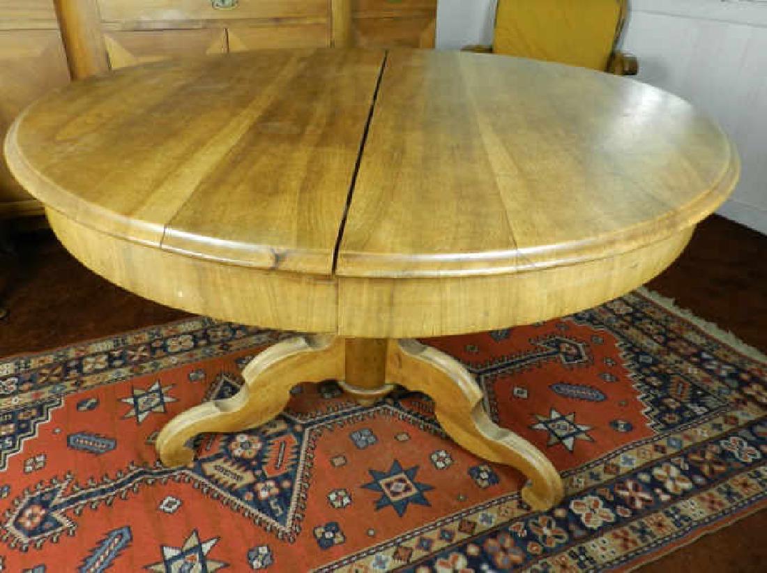Antique Walnut Dining Table On Pedestal Base: An antique walnut dining table on a pedestal base, includes 2 large leaves, table extends to reveal end support legs, 29 1/2 x 47 inches (not extended).
