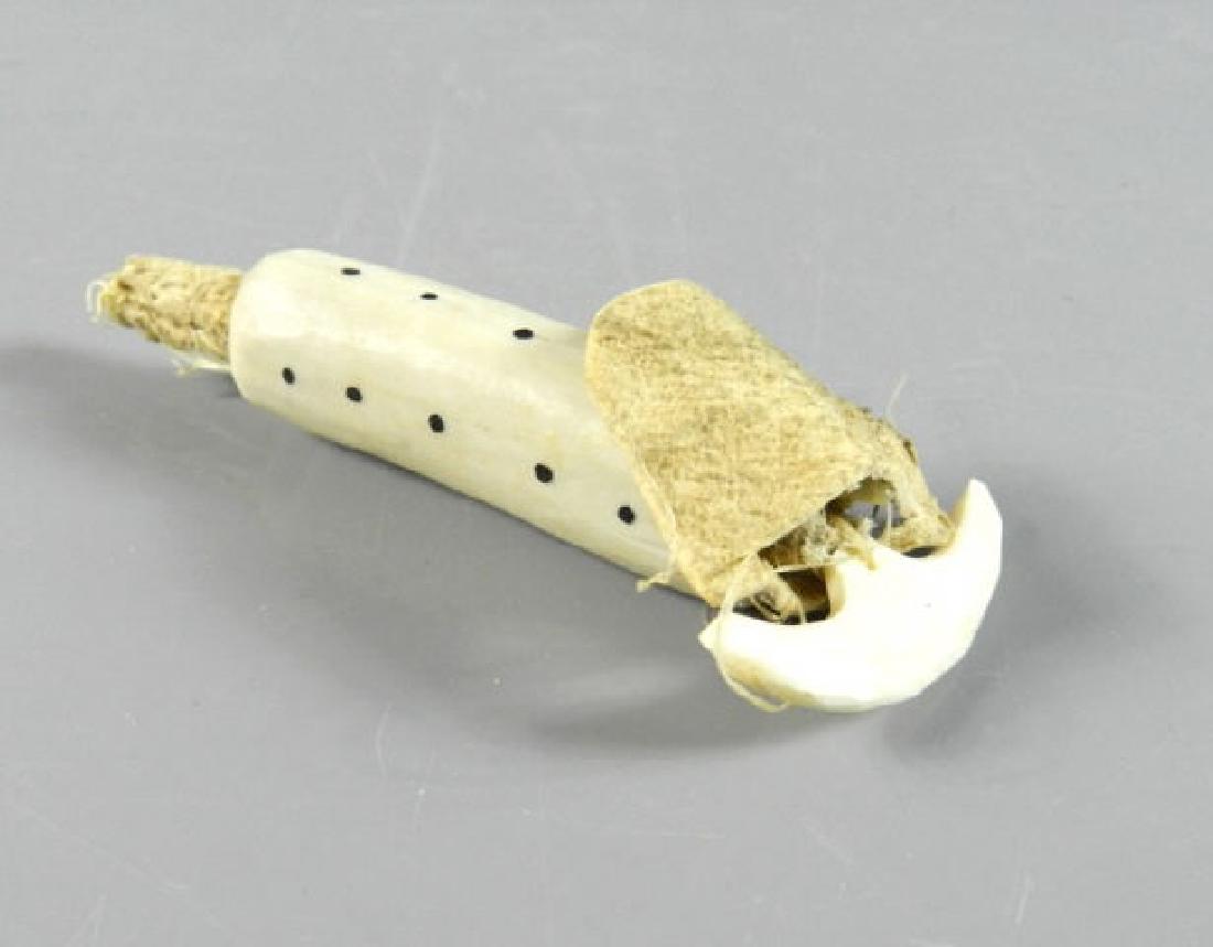 Inuit Tools - Sewing Kit: Unidentified Inuit maker, sewing kit comprising of a hide thimble, bone needle, sinew thread, the hollow bone case decorated with dots, excellent condition, provenance: collection of a prominent Montr