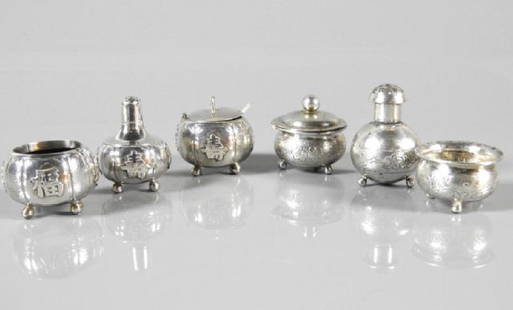 TWO SETS OF CHINESE EXPORT SALT, PEPPER & MUSTARD: Two sets of three-piece Chinese Export silver, both sets consist of salt, pepper, mustard: set shown on left by Sing Fat (1880-1930), the embossed pieces of squat form raised on bun feet, the other