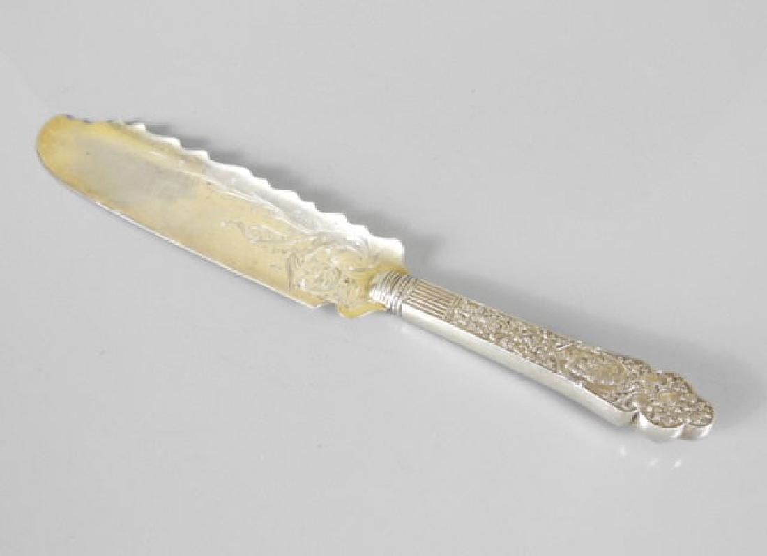 GOOD GORHAM STERLING FISH KNIFE D. 1899: A good Gorham sterling fish knife, the handle decorated with an elaborate embossed design of a lady with fruit, jester and flowers, dated 1899, 12 inches long, 149 grams.