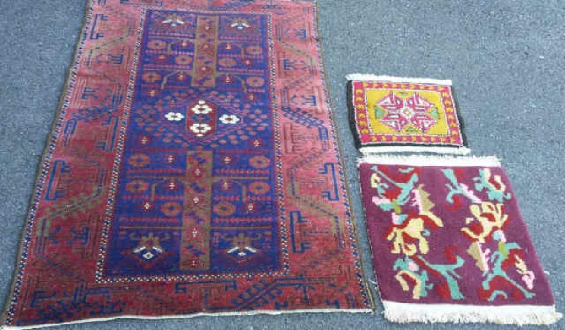 PERSIAN BELUCHI RUG & SAMPLERS: A Persian Beluchi rug, circa 1920, 5 x 3 feet along with two rug samplers, from Tibet 1.6 x 1.6 and from India 1.2 x 1.6 feet.