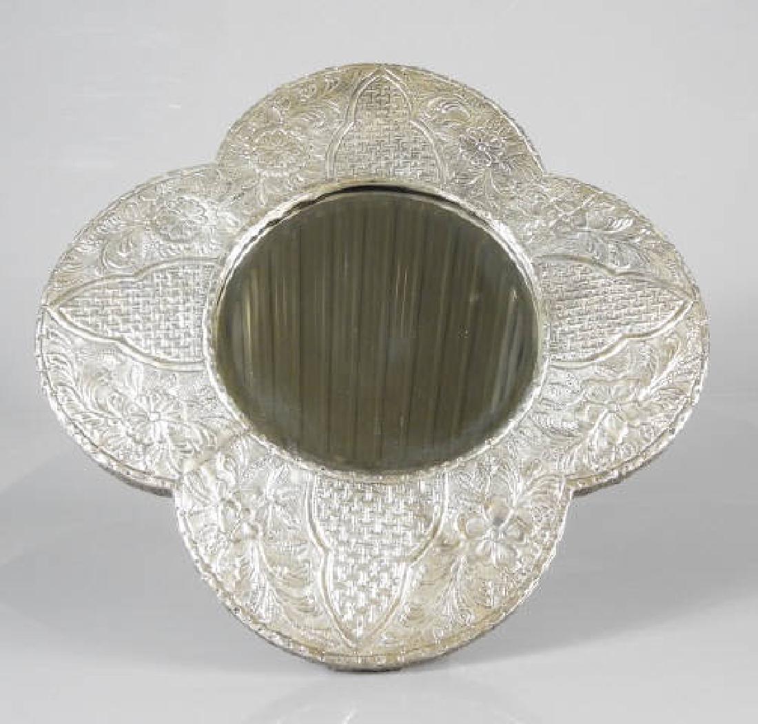 PERSIAN SILVER MIRROR: A Persian silver mirror, the four-lobed shape set with a beveled mirror, 16 inches tall.